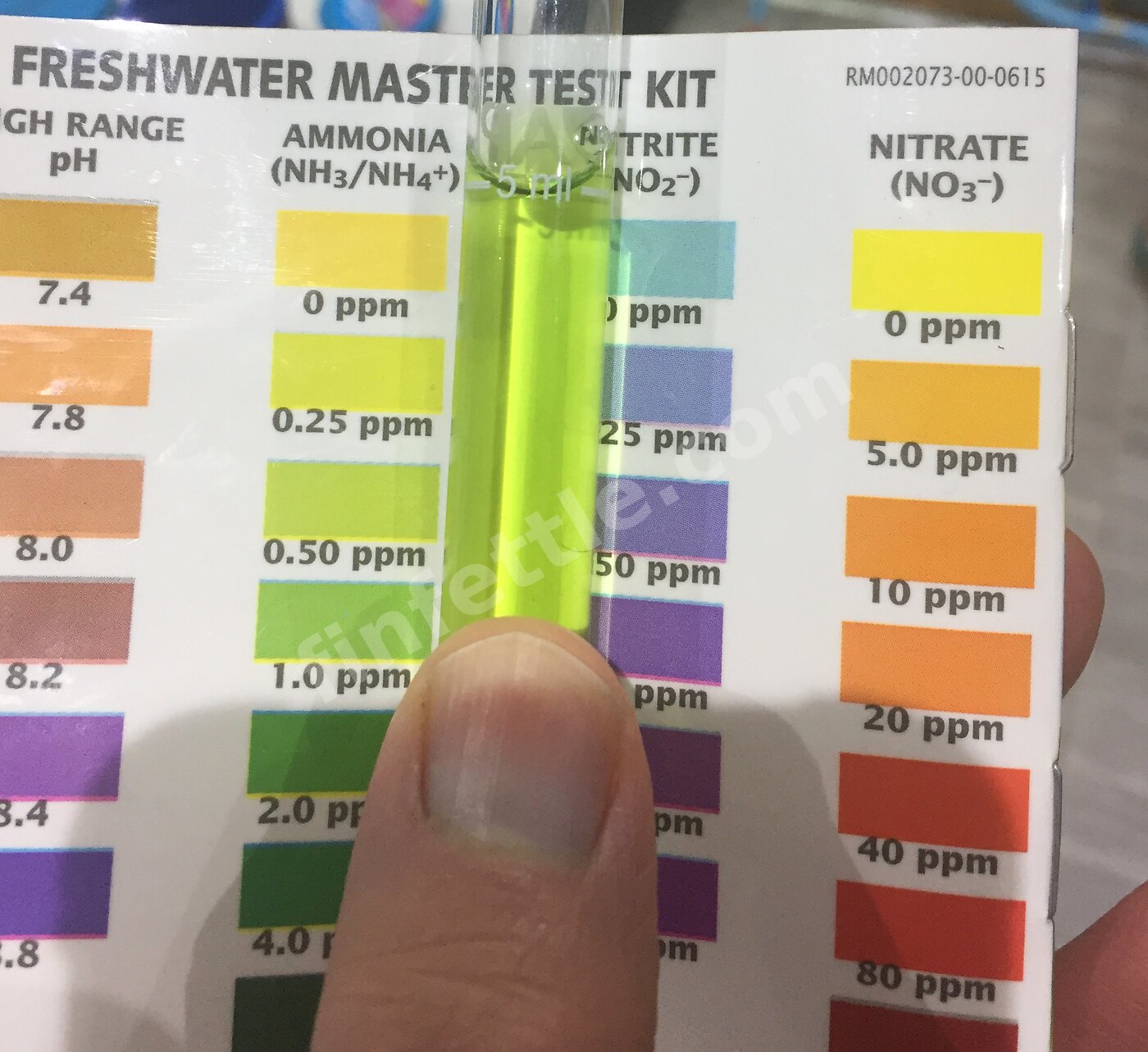 API Freshwater Master Test Kit tube held against its colour chart